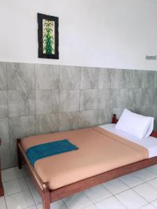 a bed in a room with at Lilacita Beach Lovina in Lovina