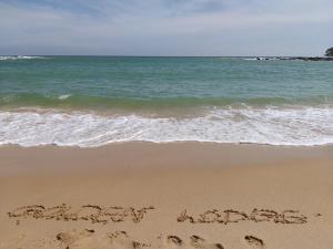 a message written in the sand on the beach at Golden Lodge Tangalle in Tangalle