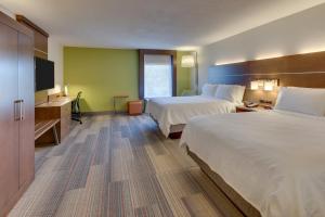 a hotel room with two beds and a flat screen tv at Holiday Inn Express & Suites Atlanta Perimeter Mall Hotel by IHG in Sandy Springs