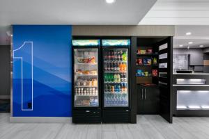 a large refrigerator filled with lots of drinks at Holiday Inn Express & Suites Milton East I-10 by IHG in Milton