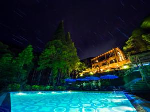 a swimming pool at night with stars at Arcadia Resorts in Deqing