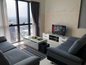 a living room with two couches and a flat screen tv at Icon City 8Pax SunwayPyramid & Lagoon CityView in Kuala Selangor