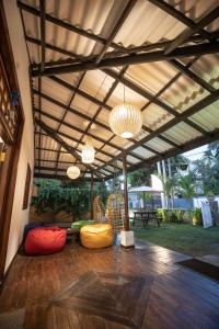 a covered patio with two bean bags and chandeliers at Luaya Beach in Tangalle