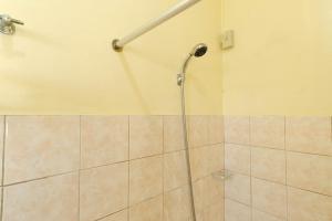 a shower with a hose in a bathroom at RedDoorz Plus @ Seaborne Hotel Subic Zambales in Subic