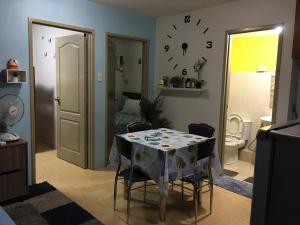 a room with a table with chairs and a bathroom at 2 BR Sorrento Oasis in Manila