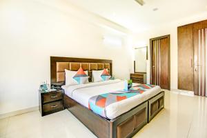 a bedroom with a large bed in a room at FabExpress Hemkunt Residency Noida in Noida