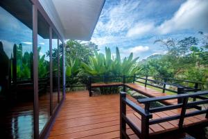 a house with a deck with benches and a mural at Baan Suan Hill Resort in Ban Tha Khun