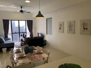 a living room with a table and a dining room at Icon City 8Pax SunwayPyramid & Lagoon CityView in Kuala Selangor