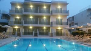a large swimming pool in front of a building at Nektar Beach Hotel in Stalos