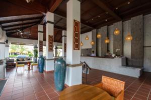 a restaurant with tables and chairs and a counter at Adena Beach Resort in Kuantan