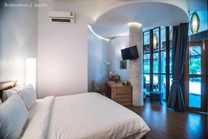 Ένα ή περισσότερα κρεβάτια σε δωμάτιο στο Koh Mak Cococape Resort