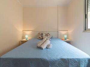 A bed or beds in a room at Bright Apartment Near The Beach In Otranto