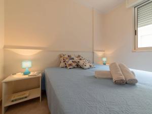 A bed or beds in a room at Bright Apartment Near The Beach In Otranto