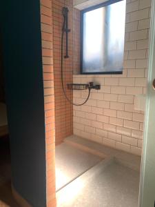 a bathroom with a shower with a window at Wontonmeen in Hong Kong
