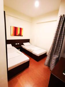 Postel nebo postele na pokoji v ubytování Orchard Hotel Davao