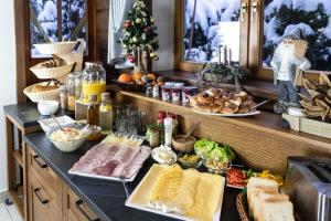 a buffet with meats and other food on a counter at Chata u Bronka in Białka Tatrzańska