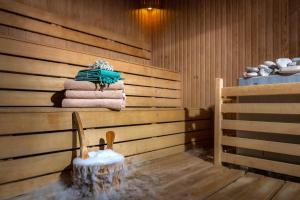 a sauna with towels on a wooden wall at Sealife Family Resort Hotel in Antalya