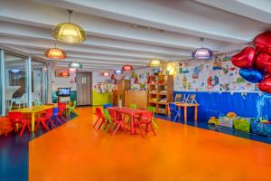 a classroom with tables and chairs and balloons at Sealife Family Resort Hotel in Antalya
