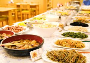 a table with many different dishes of food on it at Wakkanai Grand Hotel in Wakkanai +11 photos