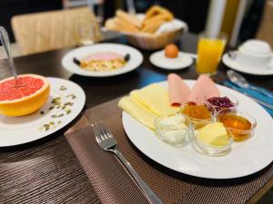 a wooden table with plates of food on it at Hotel Arena in Cologne