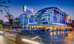 a building on a city street with traffic in front of it at Sealife Family Resort Hotel in Antalya