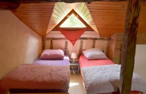 מיטה או מיטות בחדר ב-Le Grangé