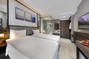 Postel nebo postele na pokoji v ubytování Ivy Hotel Nha Trang