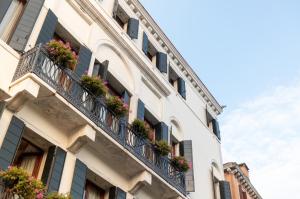 a row of windows overlooking a city street at Ca' Bonfadini Historic Experience in Venice