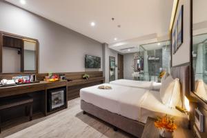 Postel nebo postele na pokoji v ubytování Ivy Hotel Nha Trang