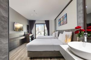 Postel nebo postele na pokoji v ubytování Ivy Hotel Nha Trang