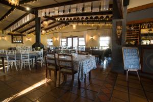 a dining room with tables and chairs in a restaurant at Damas Guest Farm in Worcester