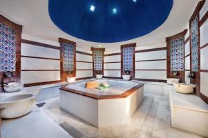 a bathroom with a large tub and two sinks at Sealife Family Resort Hotel in Antalya