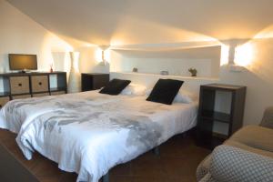 a bedroom with a large white bed with two pillows at Hotel Rural La Pedriza Original in Manzanares el Real