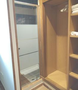 a glass shower door in a closet with towels at Casa Rural San Isidro in Valdepiélagos