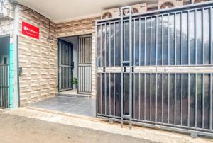 an entrance to a building with metal gates at RedDoorz near Graha Cijantung Mall in Jakarta +5 photos