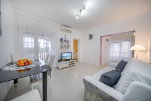 a living room with a couch and a table at Adria Sun Apartments in Vodice