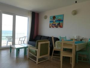 a living room with a couch and a table at Cozy studio #1, with balcony in 2 Mai