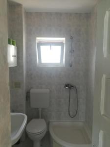 a bathroom with a toilet and a tub and a sink at Cozy studio #1, with balcony in 2 Mai +8 photos