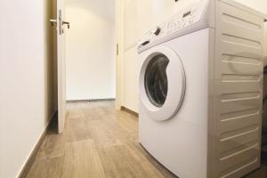 a white washer and dryer in a room at Residence ACQUA LINDA Porticcio in Porticcio
