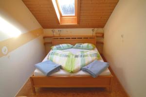 a small bedroom with a bed in a attic at Bergbauernhof Weber in Bad Hindelang