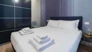 a bedroom with a white bed with towels on it at Italianway - Corso Garibaldi 104 in Milan