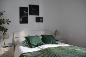 a bedroom with a bed with green pillows at Casa Amaya Rústico en Ojén in Ojén