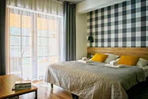 Posteľ alebo postele v izbe v ubytovaní Apartamenty Magia Gór