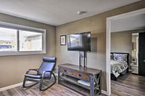 a room with a chair and a tv and a bed at Estacada Home - Near Milo McIver State Park! in Estacada