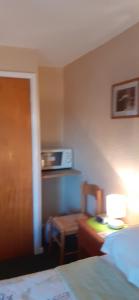 a bedroom with a bed and a table and a chair at Church Farm in Stratford-upon-Avon