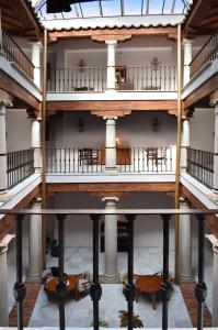 
a large room with a staircase leading up to a balcony at María de Molina in Úbeda
