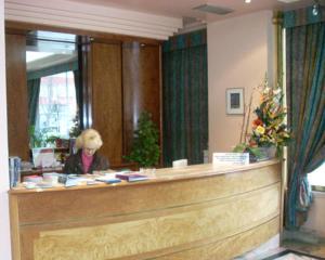 a woman standing in front of a counter in a hotel room at Hotel Estadio in Bilbao