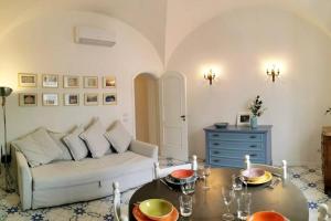 a living room with a couch and a table at Casa Ruggiero in Capri