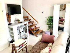 a living room with a couch and a tv at Apartment Duplex in Pančevo