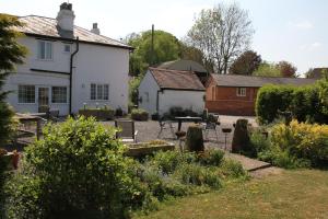 a garden in front of a white building at Church Farm in Stratford-upon-Avon